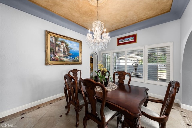 1738 N Ukiah Way, Upland, CA 91784 - dining space featuring a chandelier, baseboards, light tile patterned floors, a tray ceiling, and inlaid floor details