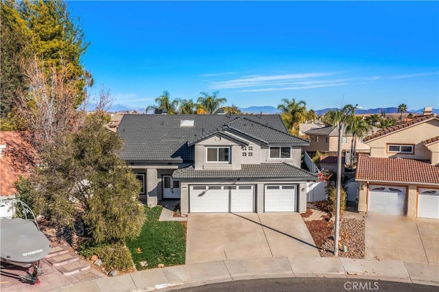 31832 Poole Ct, Temecula, CA 92591 - traditional-style house featuring a tiled roof, concrete driveway, a garage, stucco siding, and a mountain view