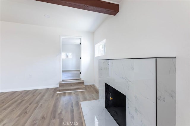 1342 W Magnolia St, Compton, CA 90220 - unfurnished living room with wood finished floors, beam ceiling, a premium fireplace, and baseboards