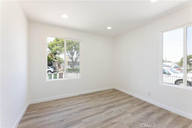 1342 W Magnolia St, Compton, CA 90220 - empty room with light wood-style floors, recessed lighting, and baseboards
