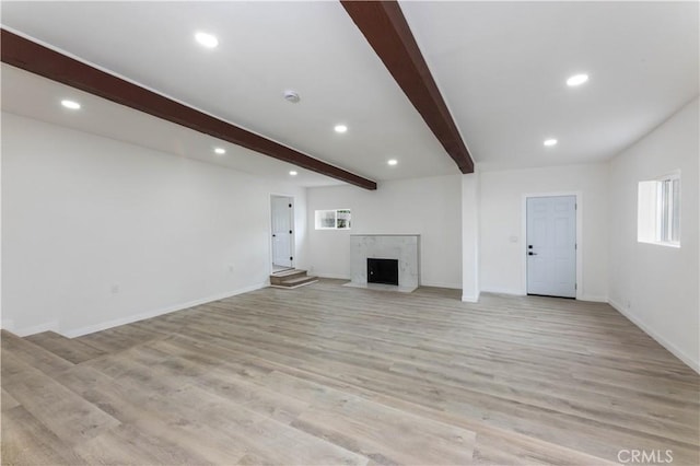 1342 W Magnolia St, Compton, CA 90220 - unfurnished living room featuring beam ceiling, light wood-style floors, recessed lighting, a fireplace, and baseboards