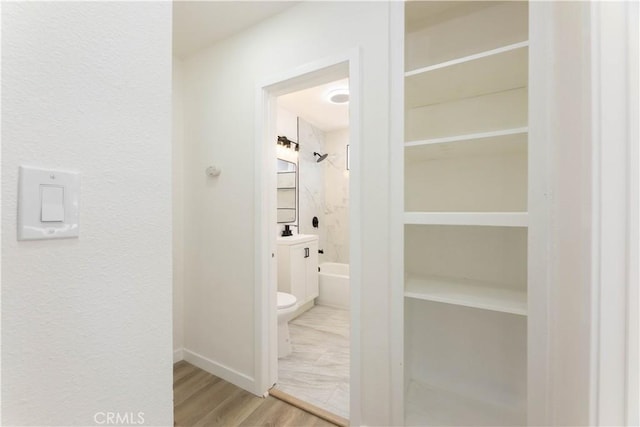 1342 W Magnolia St, Compton, CA 90220 - hallway with wood finished floors, a sink, and baseboards