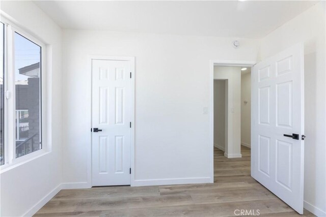 1342 W Magnolia St, Compton, CA 90220 - unfurnished bedroom featuring baseboards and light wood-style flooring