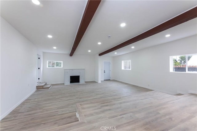 1342 W Magnolia St, Compton, CA 90220 - unfurnished living room featuring beamed ceiling, recessed lighting, a high end fireplace, light wood-type flooring, and baseboards
