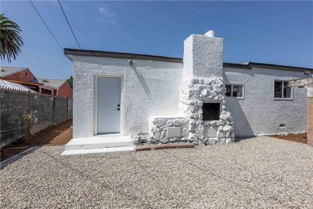 1342 W Magnolia St, Compton, CA 90220 - back of property featuring stucco siding and crawl space