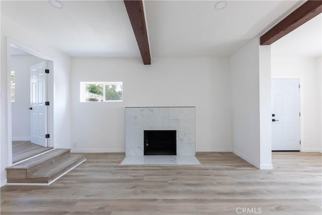 1342 W Magnolia St, Compton, CA 90220 - unfurnished living room featuring beamed ceiling, baseboards, wood finished floors, and a high end fireplace