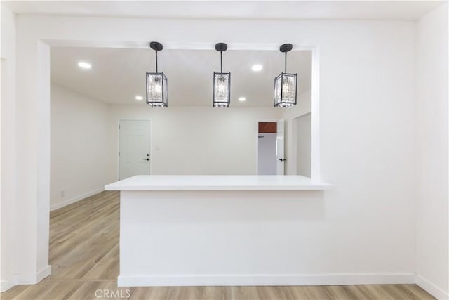 1342 W Magnolia St, Compton, CA 90220 - kitchen featuring light countertops, baseboards, recessed lighting, pendant lighting, and light wood finished floors