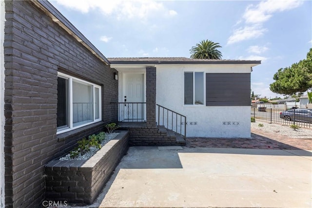 1342 W Magnolia St, Compton, CA 90220 - doorway to property featuring a patio, stucco siding, and crawl space