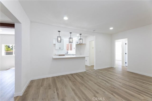 1342 W Magnolia St, Compton, CA 90220 - unfurnished living room with light wood-type flooring, recessed lighting, and baseboards