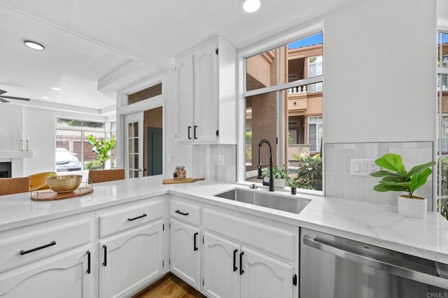 3581 Cameo Dr Unit 35, Oceanside, CA 92056 - kitchen featuring stainless steel dishwasher, light stone countertops, white cabinetry, recessed lighting, and healthy amount of natural light