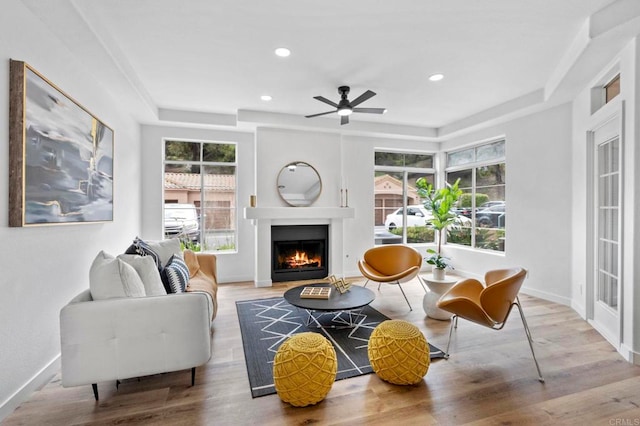 3581 Cameo Dr Unit 35, Oceanside, CA 92056 - living area featuring a lit fireplace, a ceiling fan, wood finished floors, recessed lighting, and a raised ceiling