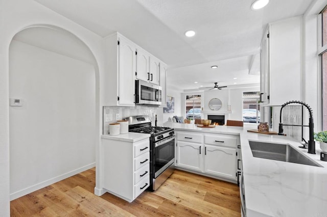 3581 Cameo Dr Unit 35, Oceanside, CA 92056 - kitchen with appliances with stainless steel finishes, a ceiling fan, recessed lighting, white cabinetry, and light wood-style flooring