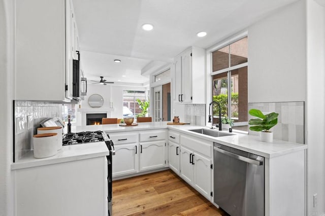 3581 Cameo Dr Unit 35, Oceanside, CA 92056 - kitchen with dishwasher, black range with gas stovetop, ceiling fan, recessed lighting, and tasteful backsplash