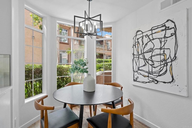3581 Cameo Dr Unit 35, Oceanside, CA 92056 - dining space with a chandelier, healthy amount of natural light, and wood finished floors