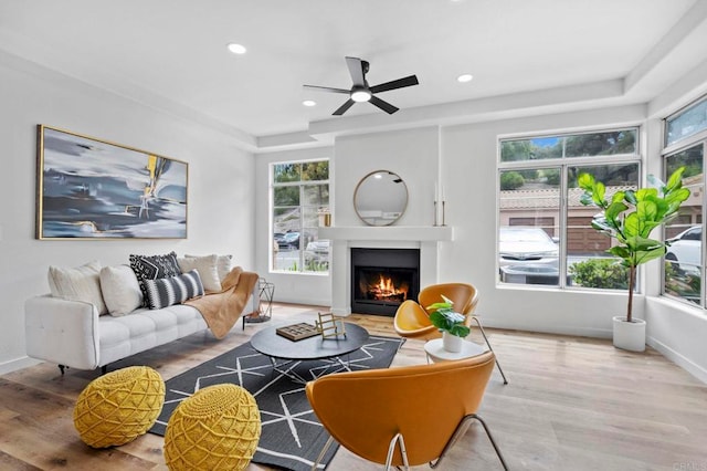 3581 Cameo Dr Unit 35, Oceanside, CA 92056 - living room featuring wood finished floors, a lit fireplace, ceiling fan, recessed lighting, and a tray ceiling
