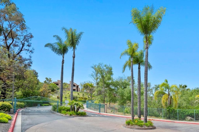 3581 Cameo Dr Unit 35, Oceanside, CA 92056 - view of asphalt road with curbs, a gate, and a gated entry