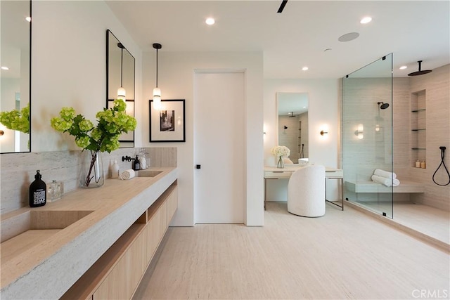 16828 Otsego St, Encino, CA 91436 - bathroom with tiled shower, double vanity, tasteful backsplash, wood finished floors, and recessed lighting