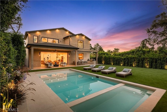 16828 Otsego St, Encino, CA 91436 - back of property with outdoor lounge area, a yard, a pool with connected hot tub, a patio area, and stucco siding