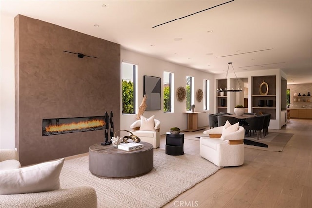 16828 Otsego St, Encino, CA 91436 - living room featuring light wood-type flooring and a large fireplace