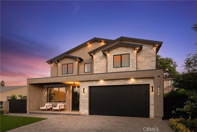 16828 Otsego St, Encino, CA 91436 - contemporary house with decorative driveway, an attached garage, and stone siding