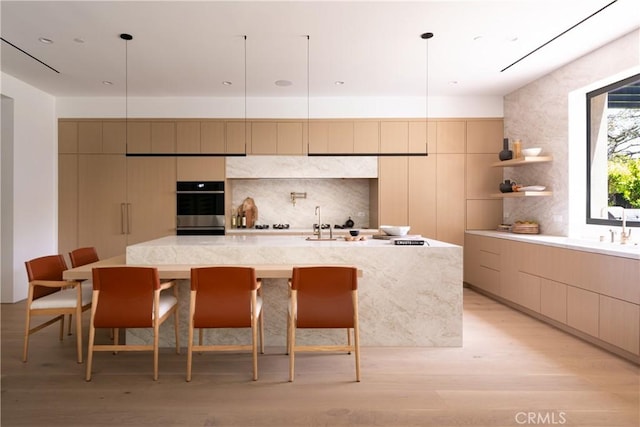 16828 Otsego St, Encino, CA 91436 - kitchen featuring modern cabinets, light wood-style floors, tasteful backsplash, and double oven
