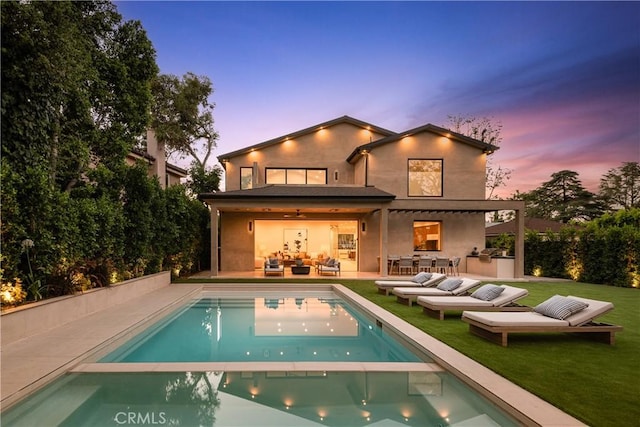 16828 Otsego St, Encino, CA 91436 - rear view of house with an outdoor living space, a pool with connected hot tub, area for grilling, a yard, and stucco siding