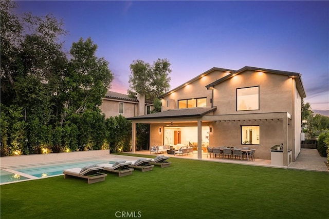 16828 Otsego St, Encino, CA 91436 - rear view of house featuring an outdoor living space, a lawn, a patio, and an outdoor pool