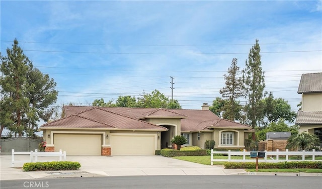 6530 Encina St, Chino, CA 91710 - view of front of property featuring stucco siding, driveway, a garage, and a tiled roof