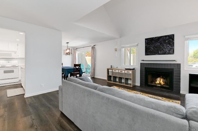 11855 Caminito Ronaldo Unit 108, San Diego, CA 92128 - living area with dark wood-type flooring, a fireplace, healthy amount of natural light, and a chandelier