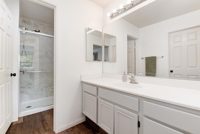 11855 Caminito Ronaldo Unit 108, San Diego, CA 92128 - full bath with vanity, a stall shower, wood finished floors, and baseboards