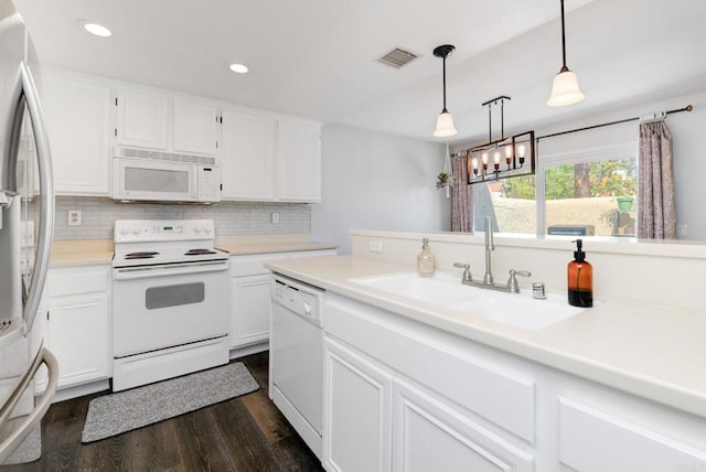 11855 Caminito Ronaldo Unit 108, San Diego, CA 92128 - kitchen with white appliances, dark wood-style floors, a sink, white cabinetry, and light countertops