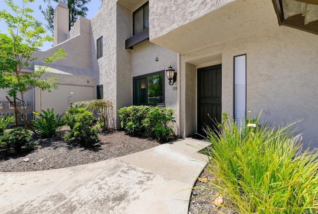 11855 Caminito Ronaldo Unit 108, San Diego, CA 92128 - property entrance featuring stucco siding and a chimney