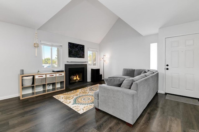 11855 Caminito Ronaldo Unit 108, San Diego, CA 92128 - living room with a lit fireplace, dark wood-style flooring, vaulted ceiling, and baseboards