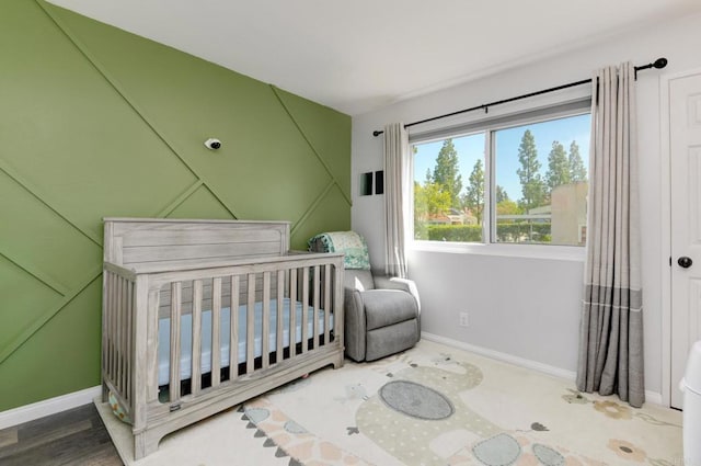 11855 Caminito Ronaldo Unit 108, San Diego, CA 92128 - bedroom with baseboards and a nursery area