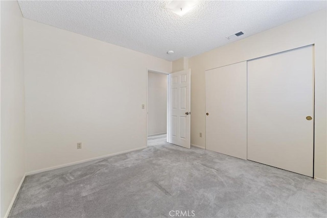 42330 61st St W, Lancaster, CA 93536 - unfurnished bedroom featuring carpet floors, a textured ceiling, a closet, and baseboards