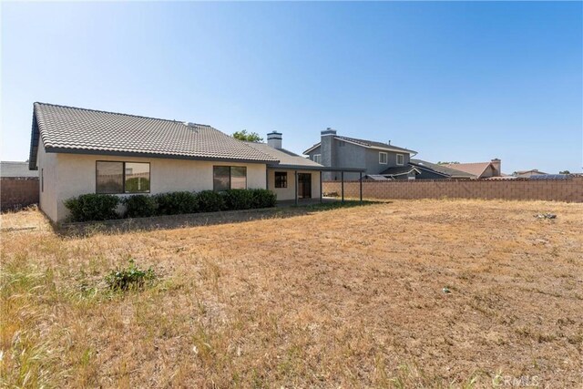 42330 61st St W, Lancaster, CA 93536 - back of property with stucco siding, a tile roof, and a chimney