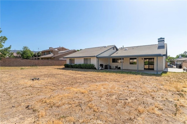 42330 61st St W, Lancaster, CA 93536 - back of property featuring a patio, a tile roof, and a chimney