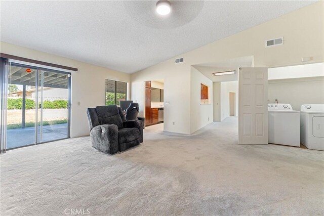 42330 61st St W, Lancaster, CA 93536 - sitting room with washing machine and dryer, lofted ceiling, light carpet, and a textured ceiling