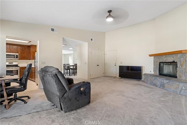 42330 61st St W, Lancaster, CA 93536 - living area featuring light colored carpet, vaulted ceiling, a fireplace, and a ceiling fan