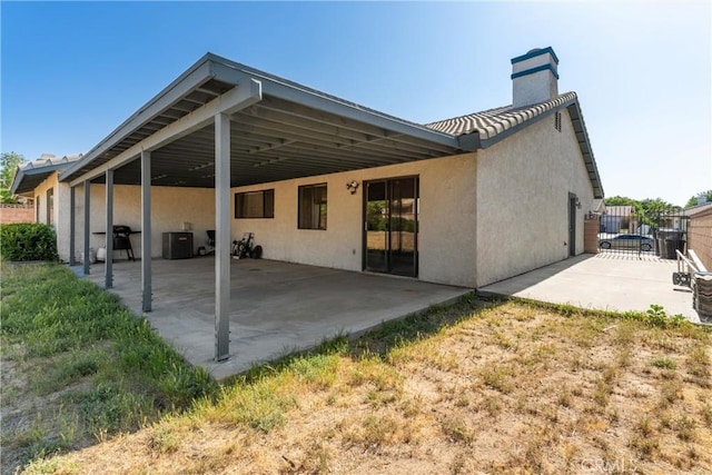 42330 61st St W, Lancaster, CA 93536 - back of property featuring stucco siding, a chimney, and a carport