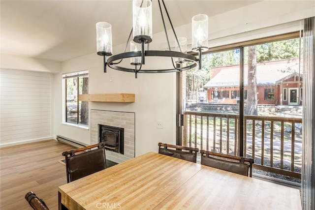 152 Viewpoint Rd Unit 105, Mammoth Lakes, CA 93546 - dining area featuring a chandelier, baseboard heating, wood finished floors, and baseboards