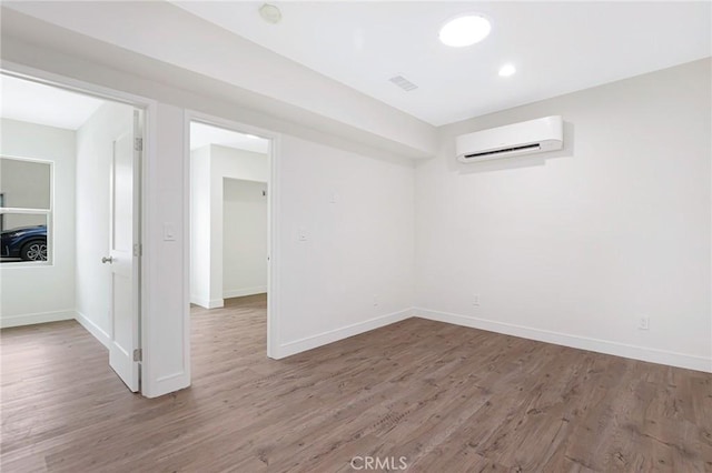 4612 W 132nd St, Hawthorne, CA 90250 - empty room featuring a wall mounted AC, wood finished floors, and baseboards