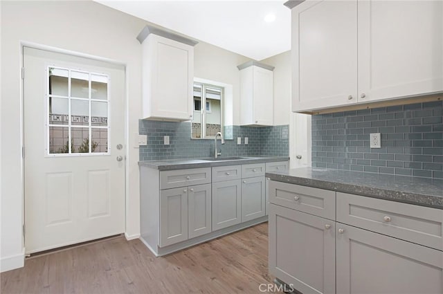 4612 W 132nd St, Hawthorne, CA 90250 - kitchen featuring a sink, light wood-style flooring, and decorative backsplash