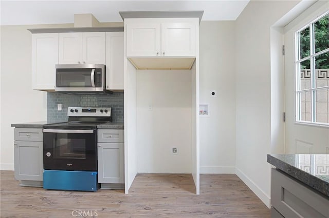 4612 W 132nd St, Hawthorne, CA 90250 - kitchen with appliances with stainless steel finishes, light wood-style flooring, decorative backsplash, and baseboards