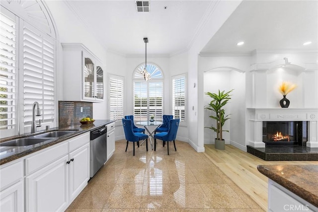 14121 Exeter Ct, Fontana, CA 92336 - kitchen with dishwasher, a sink, granite tiled floors, baseboards, and crown molding