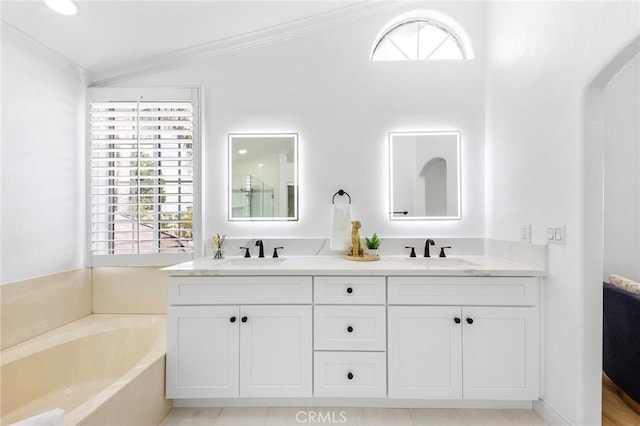 14121 Exeter Ct, Fontana, CA 92336 - bathroom featuring ornamental molding, double vanity, and a garden tub