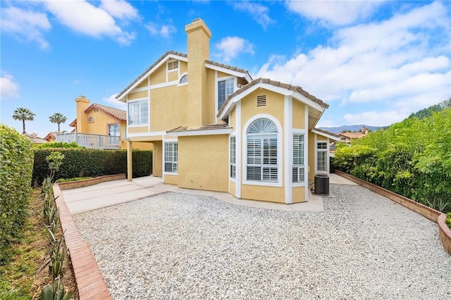 14121 Exeter Ct, Fontana, CA 92336 - rear view of property featuring a chimney, stucco siding, a patio area, and a tile roof