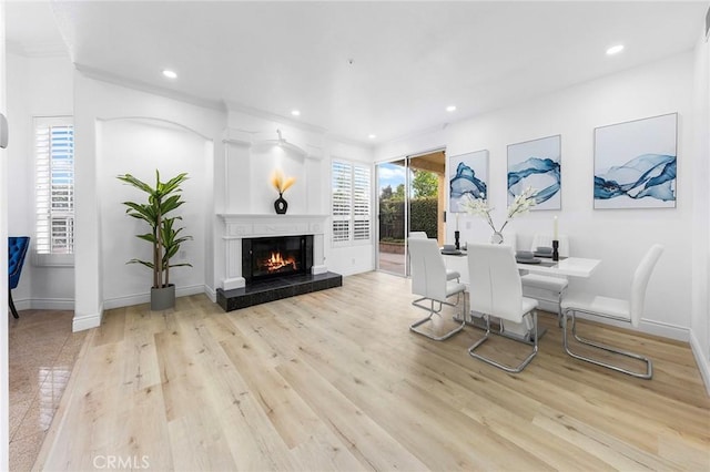 14121 Exeter Ct, Fontana, CA 92336 - dining space featuring wood finished floors, a high end fireplace, recessed lighting, ornamental molding, and baseboards