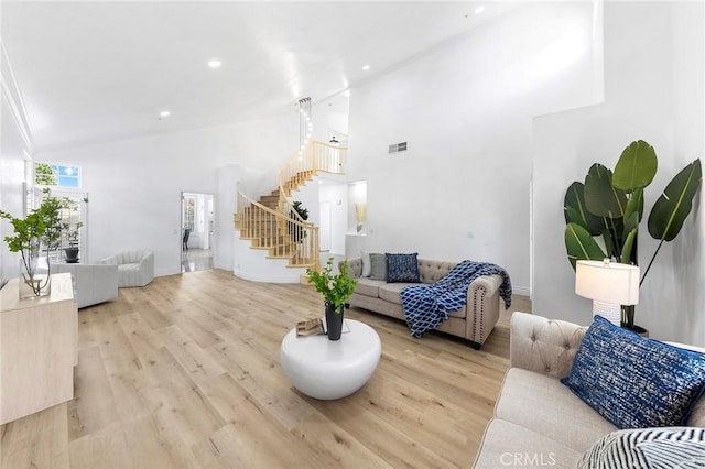 14121 Exeter Ct, Fontana, CA 92336 - living area featuring stairs, wood finished floors, high vaulted ceiling, baseboards, and recessed lighting