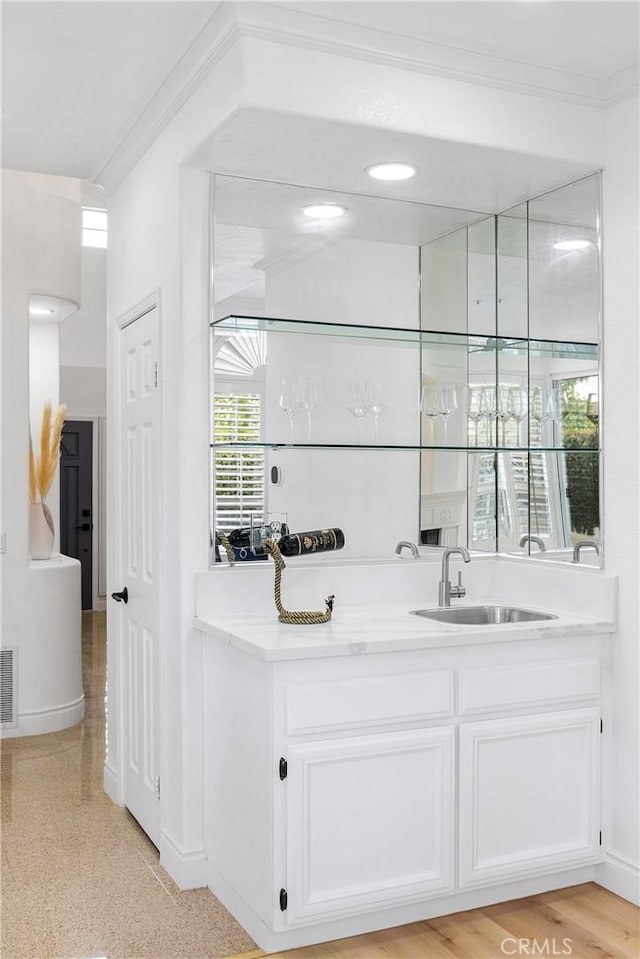 14121 Exeter Ct, Fontana, CA 92336 - indoor wet bar featuring crown molding and baseboards